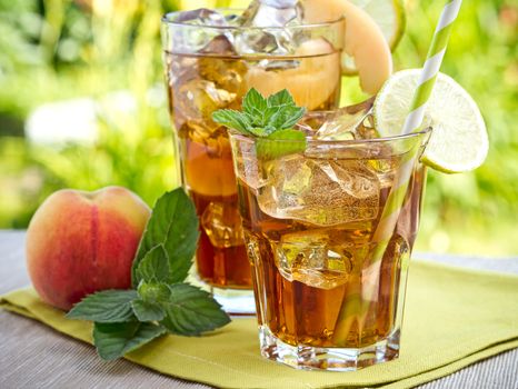 Refreshing peach, lime and mint ice tea served outdoors