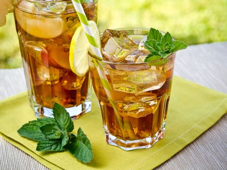 Refreshing peach, lime and mint ice tea served outdoors