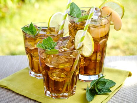 Refreshing peach, lime and mint ice tea served outdoors