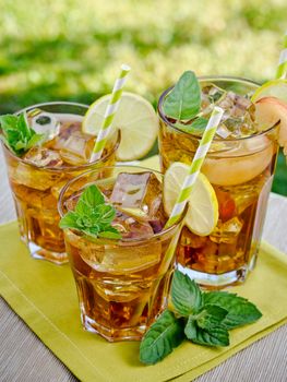 Refreshing peach, lime and mint ice tea served outdoors