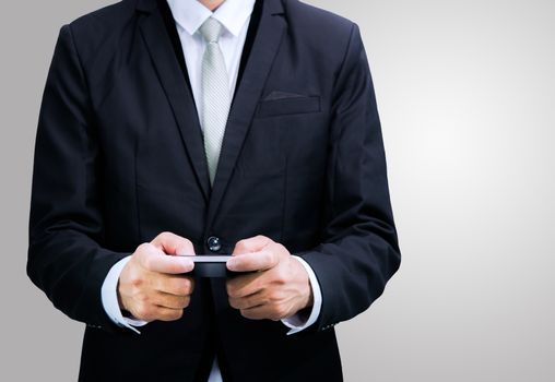 Businessman standing posture hand hold phone isolated on over gray background