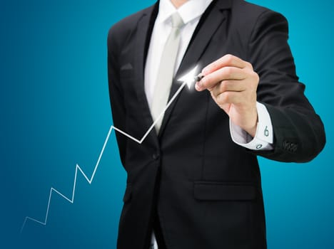 Businessman hand drawing a graph Isolated on blue background