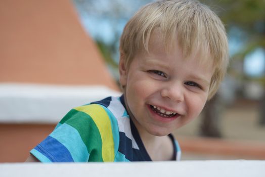 Portrait of cute little smiling blond boy