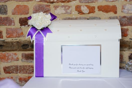 Wedding reception cardbox closeup showing purple ribbon detail