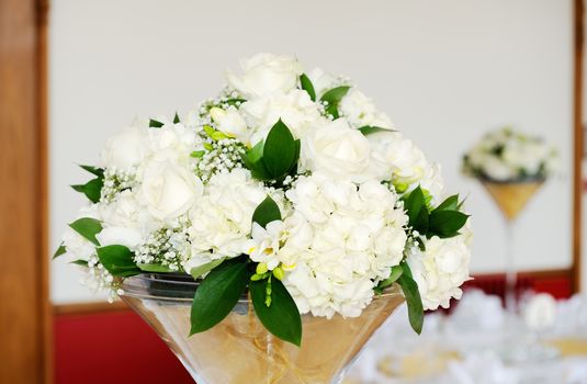 Wedding reception white floral arrangements decorating tables