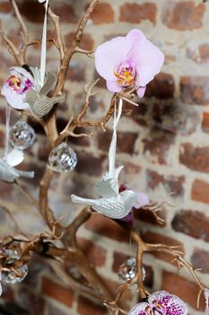 Wedding reception decorations in closeup detail showing bonsai tree with doves and flowers