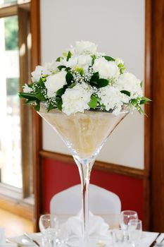 White floral arrangement with white flowers at wedding reception