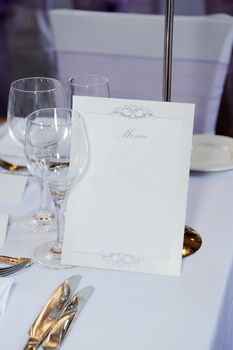 Wedding reception closeup of menu on table next to glasses