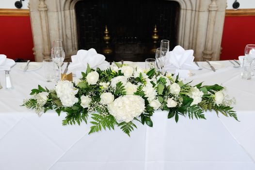 Floral arrangement of white flowers at wedding reception