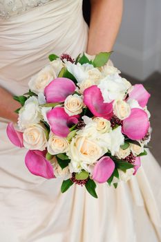 Bride holding her vibrant and colourful flowers.