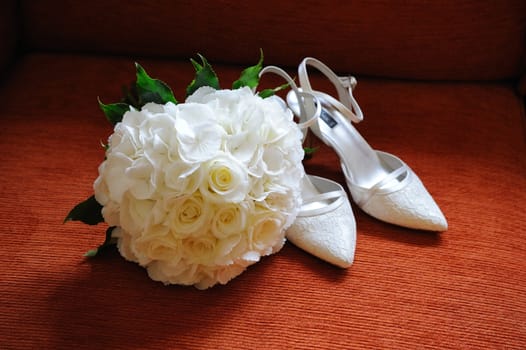 Brides white roses and white shoes.