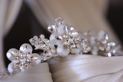 Close up of brides tiara resting on her shoes.