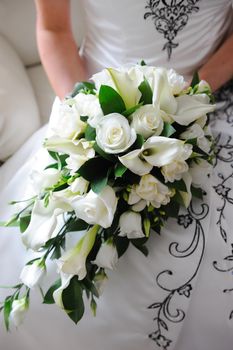 Brides bouquet is white roses.