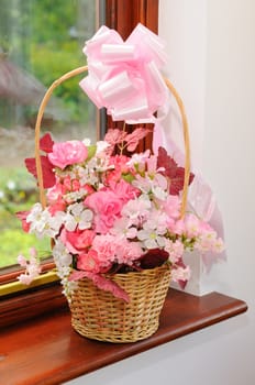 Flower girls basket of pink and white flowers.