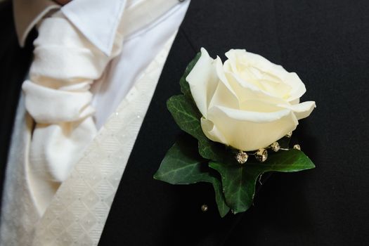 Grooms buttonhole is a white rose.