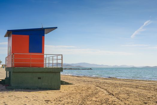 Red lifeguard house on the sandy beach