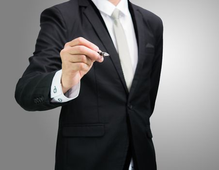 Businessman standing posture hand hold a pen isolated on over gray background