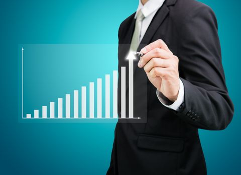 Businessman hand drawing a graph Isolated on blue background