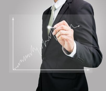 Businessman hand drawing a graph Isolated on gray background