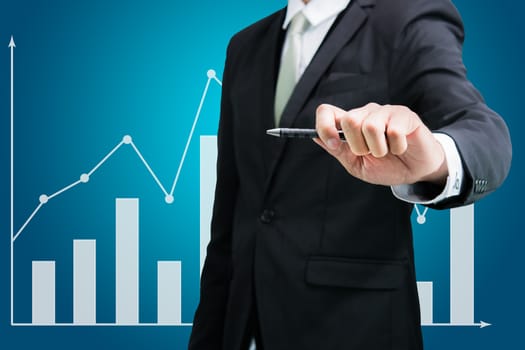 Businessman hand drawing a graph Isolated on blue background