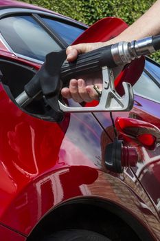 Pumping Gas - Filling a cars fuel tank with diesel or petroleum.