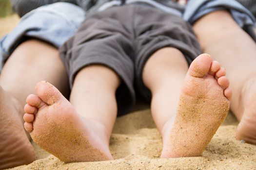 children's feet in the sand