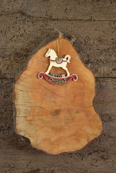 Rustic Christmas decoration, rocking horse on old wooden background
