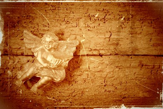 Golden Angel in old wooden background with copy space