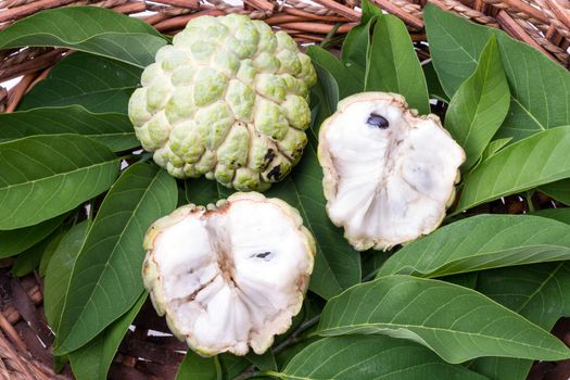 Custard apple with leaves in wicker basket