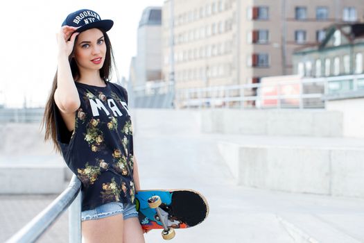 Street, outdoor. Attractive teen in a cap