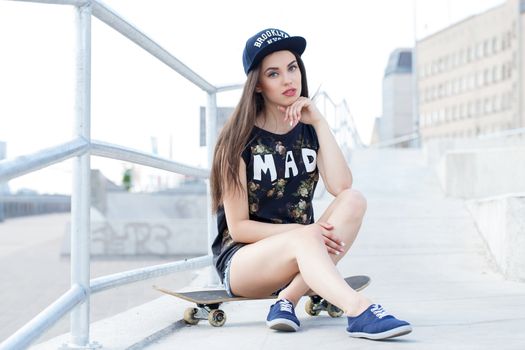 Street, outdoor. Attractive teen in a cap