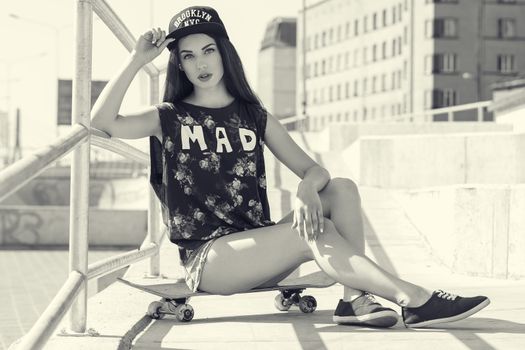 Street, outdoor. Attractive teen in a cap