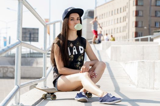 Street, outdoor. Attractive teen in a cap