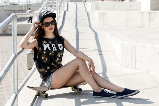 Street, outdoor. Attractive teen in a cap