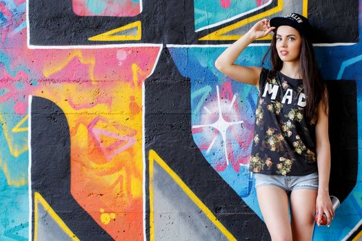 Street, outdoor. Attractive teen in a cap