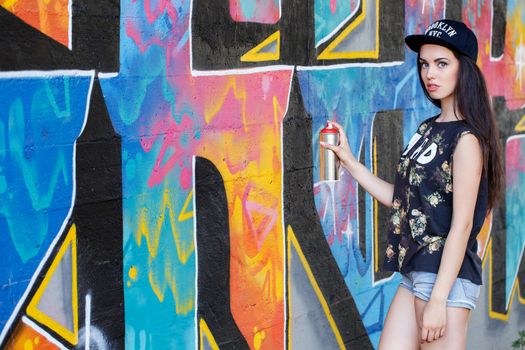 Street, outdoor. Attractive teen in a cap