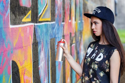 Street, outdoor. Attractive teen in a cap