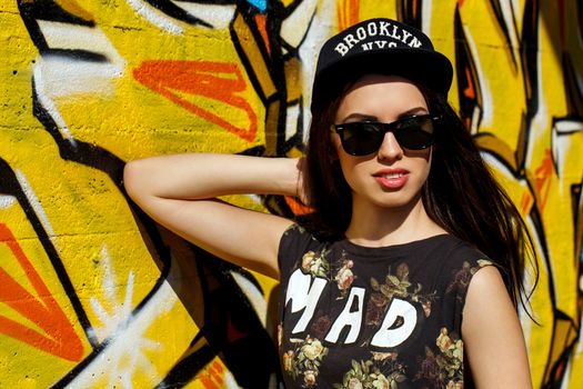 Street, outdoor. Attractive teen in a cap