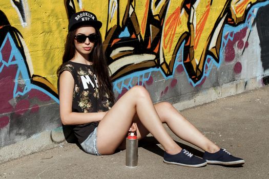 Street, outdoor. Attractive teen in a cap