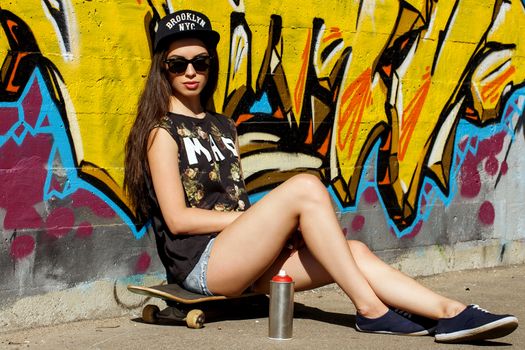 Street, outdoor. Attractive teen in a cap