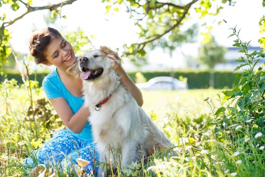 Cute girl in blue dress with adorable dog