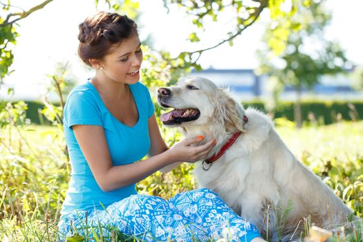 Cute girl in blue dress with adorable dog