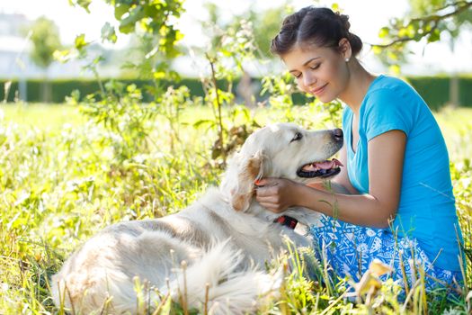 Cute girl in blue dress with adorable dog