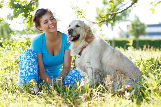 Cute girl in blue dress with adorable dog