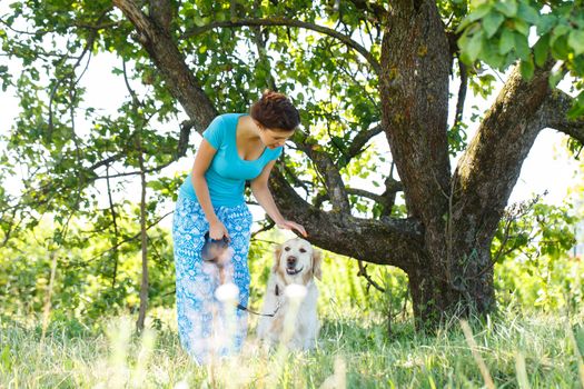 Cute girl in blue dress with adorable dog