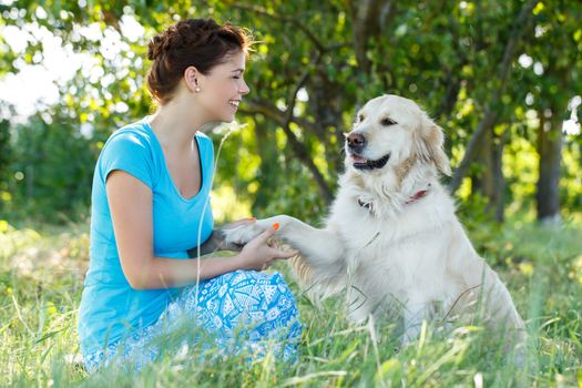 Cute girl in blue dress with adorable dog