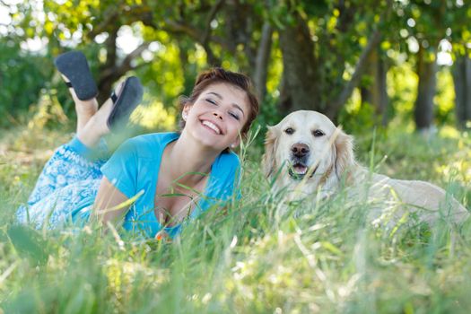 Cute girl in blue dress with adorable dog