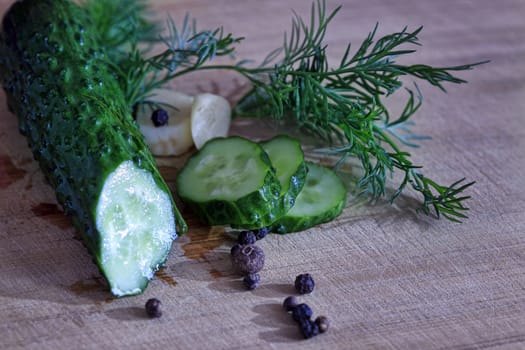 Pickled cucumber still life on old plank