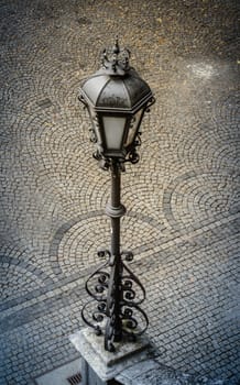 Detail Of An Old Street Lamp In A European Cobblestone Courtyard