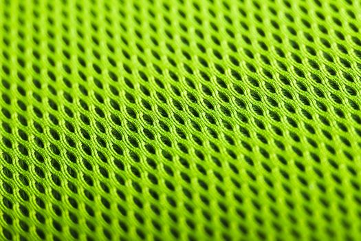 green background. Mesh fabric texture. Macro perspective